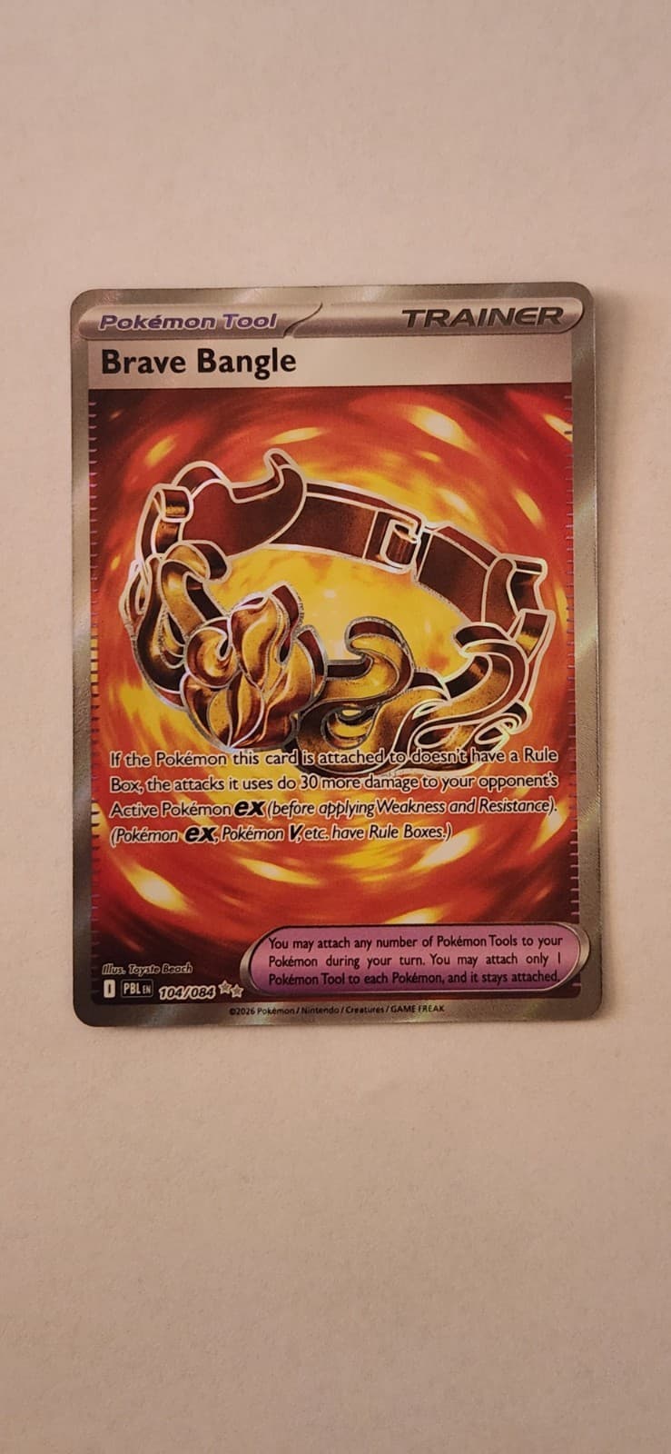 Brave Bangle - #104/084 - ME05: Pitch Black Pokemon NM