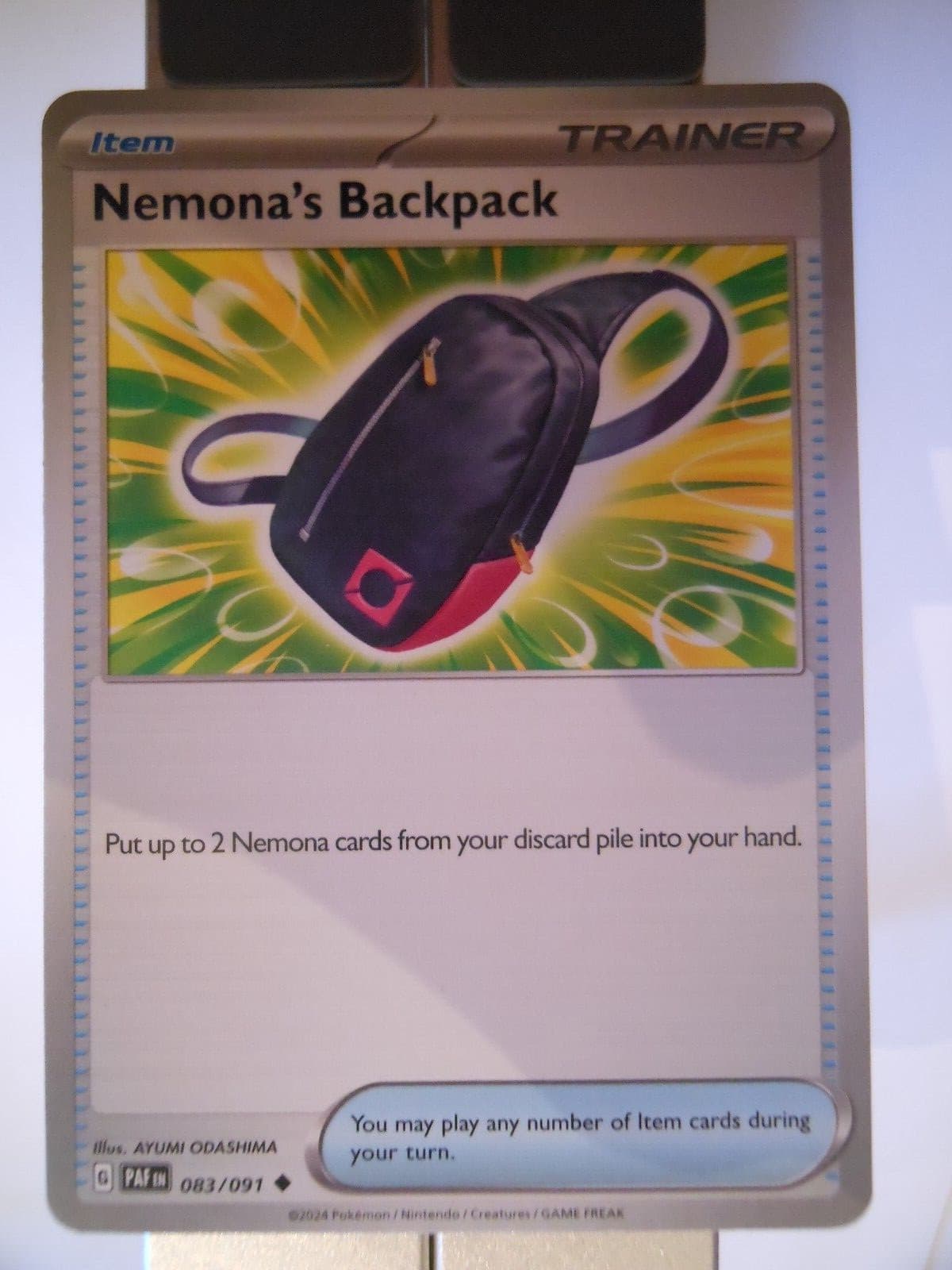 134PK83 - Nemona's Backpack- 83/91 - Paldean Fates (PAF) - Uncommon